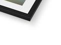 A picture frame on a dark background with a white object beside it.