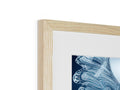 A frame that is in blue and black wood with a picture in it's frame.
