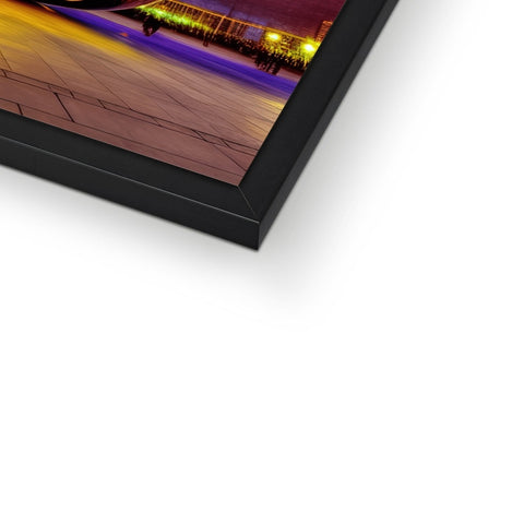 A picture frame holding a black and white photo with some colorful lights on it.