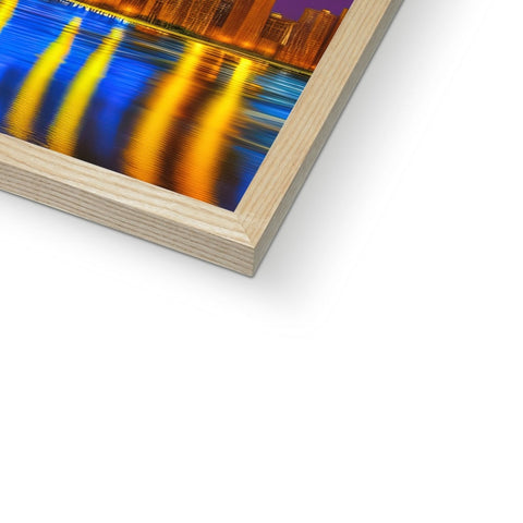 A wooden frame with an art print near a picture of a city skyline.