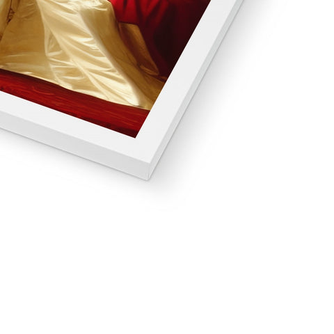 A picture of a red bed on a red pillow with a picture frame on it.