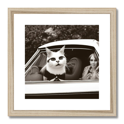 This white photo is on a wooden frame that has a frame near a cat.