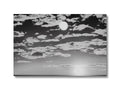 A tray with a silver card with a sunset sky background.