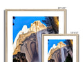 Wooden picture frames with a mountain and a tree in the background of an image on