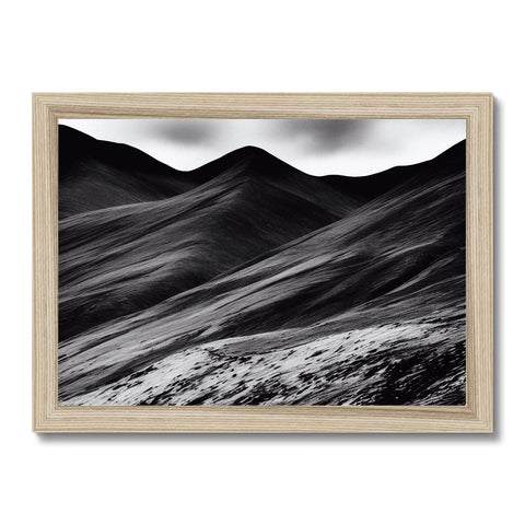 a picture frame with mountain peaks in a desert setting next to lush green grass in a