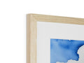 A photo of a wood framed image in a blue and white frame.