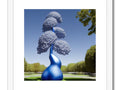 Art work set in topiary that has a blue blue sky, green sky, and