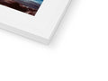 A white picture frame with a white book on the top of it.