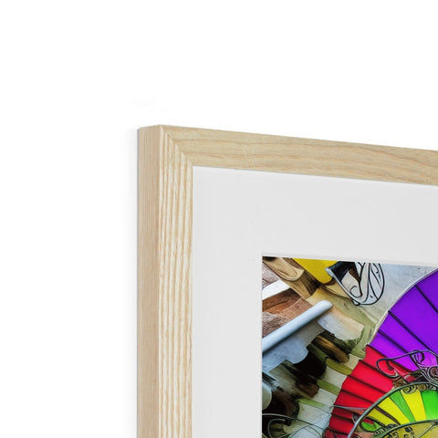 A rainbow photo frame sits on a wooden case with a spinning wheel.