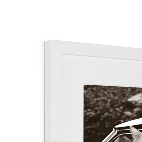 A picture frame sitting on top of a white wall with a picture of a car.