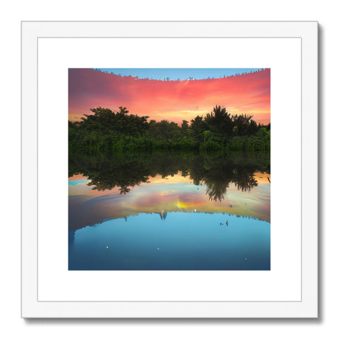 An art print with a sunset scene in front of a lake in the background.