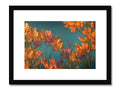 A bunch of colorful flowers sitting on a piece of white fabric in a framed print.