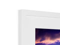 A small white picture frame sitting on top of a small display screen.
