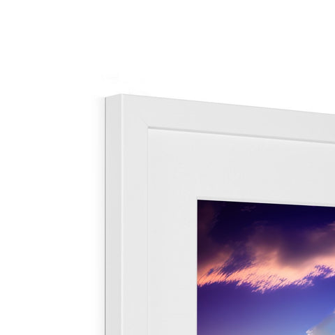 A small white picture frame sitting on top of a small display screen.