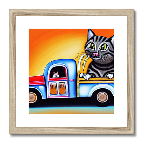 a black and white cat standing on top of an art print in a motor home