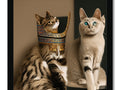 Two cats staring into glass at an ornamented picture of an old Egyptian design.