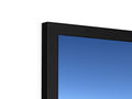 A close up of a flat screen television monitor next to a white wall.