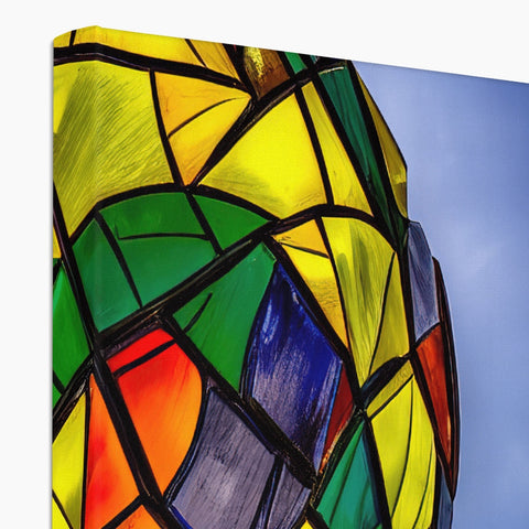 A large glass pole topped pole shaped table with stained glass on it.