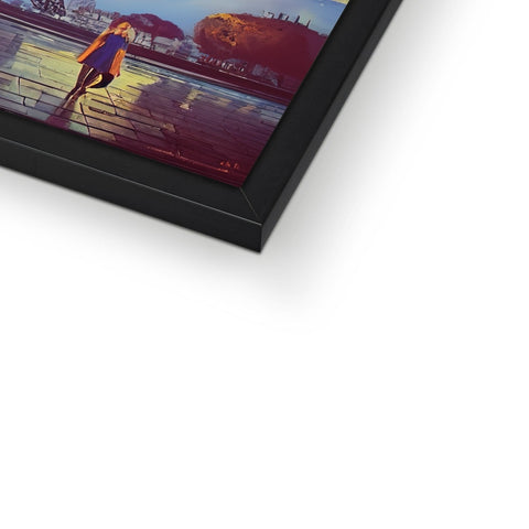 A picture frame with a person holding an electronic tablet in a photo frame sitting on a