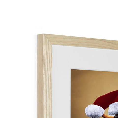 A fireplace has a large white wooden and red framed picture of a child sitting on it