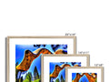 A mountain and mountain panorama on a picture frame mounted on wood with colorful prints.