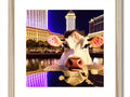 Three cow statues are standing inside a glass frame in a frame in Las Vegas on a