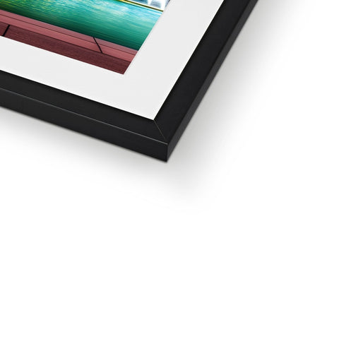 A print is sitting on top of a photo of a picture frame on a table.