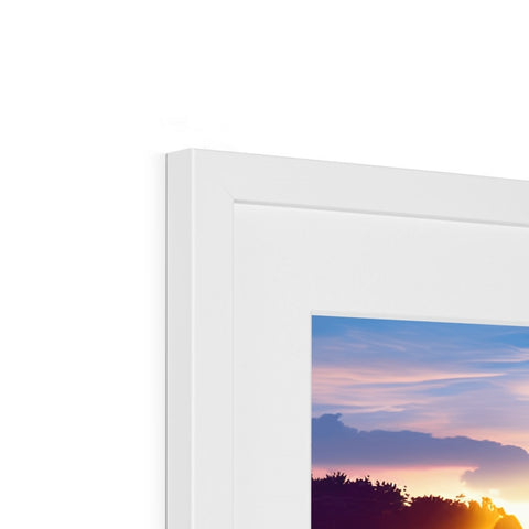 A photo of a picture frame in a white frame on a blue wall.