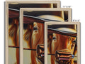 A group of framed pictures of two horses wearing cowboy hats sitting on the side of a