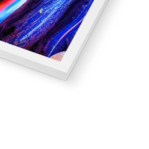 An imac on a wall holding an art book with a white picture on it.