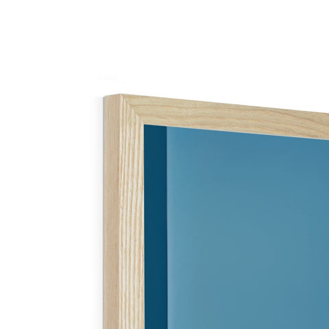 A blue photo frame inside of a wood framed frame sitting together on a floor.