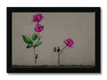 Art print of two pink flowers on a wooden table.