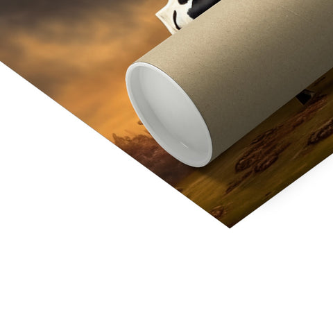 A paper roll is holding a topper as it sits on a white towel roll.