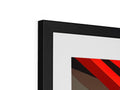 A large picture frame showing a red triangle under a mirror beside a piece of art on