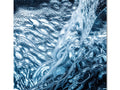 Wavy, turbulent water is reflected on the body of water with an art print for