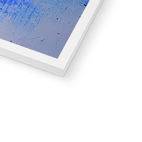 Some small picture of a blue art print on a large white paper frame in front of