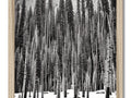 An art print framed in silver with pine trees and snow.