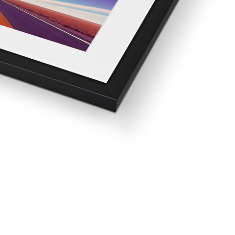 A picture frame sitting on a wooden frame on a white table with an abstract image in