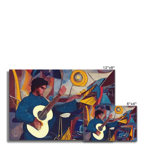 A man on a guitar playing in front of a collage of paintings.