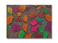 A beautiful colorful place mat with lots of leaves on it.