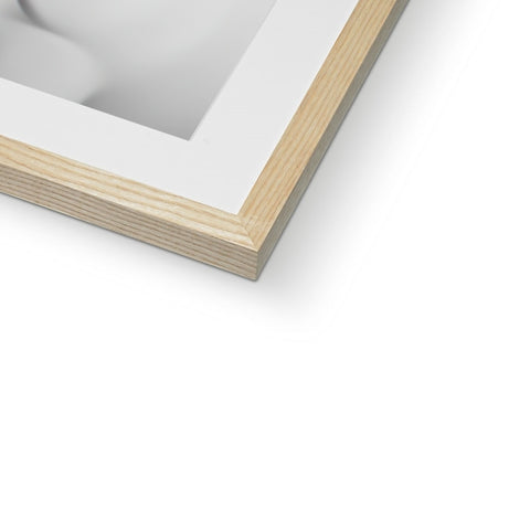 A tall white picture frame sitting on top of a wood wall with a wooden framed