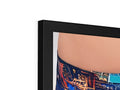 A laptop lying on a frame with a photo of a man's stomach looking at it