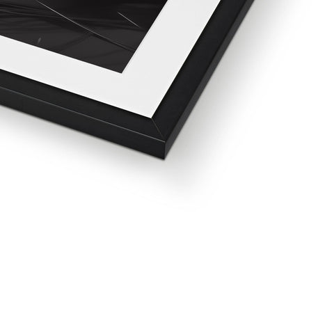 A square picture frame that has a mirror placed back in black and white.