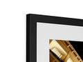A picture frame with a gold and black television on one side and black photo framed on