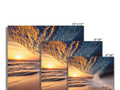 A picture panel with four photographs floating on top of a table top.