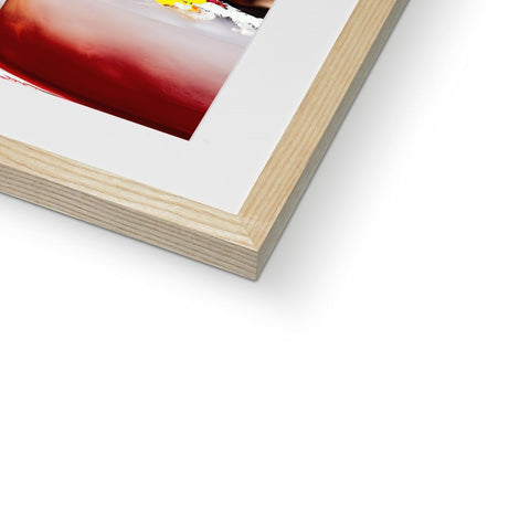 A wine glass  on a hard cover photo is sitting on a frame.