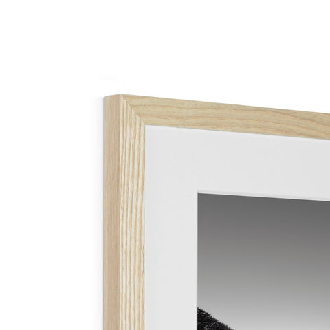 A white picture frame with three different pictures sitting underneath a close up of a mirror.