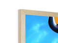 A very large picture of a wood framed object on a shelf.