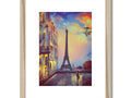 A yellow framed picture of a beautiful picture of Paris is on a wooden frame.