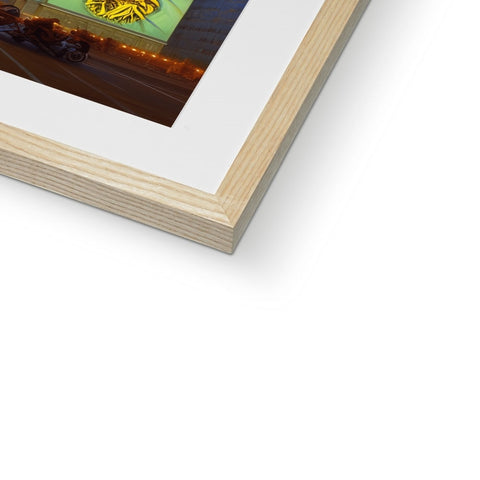 An image of the picture on a wood frame with an object next to it in a